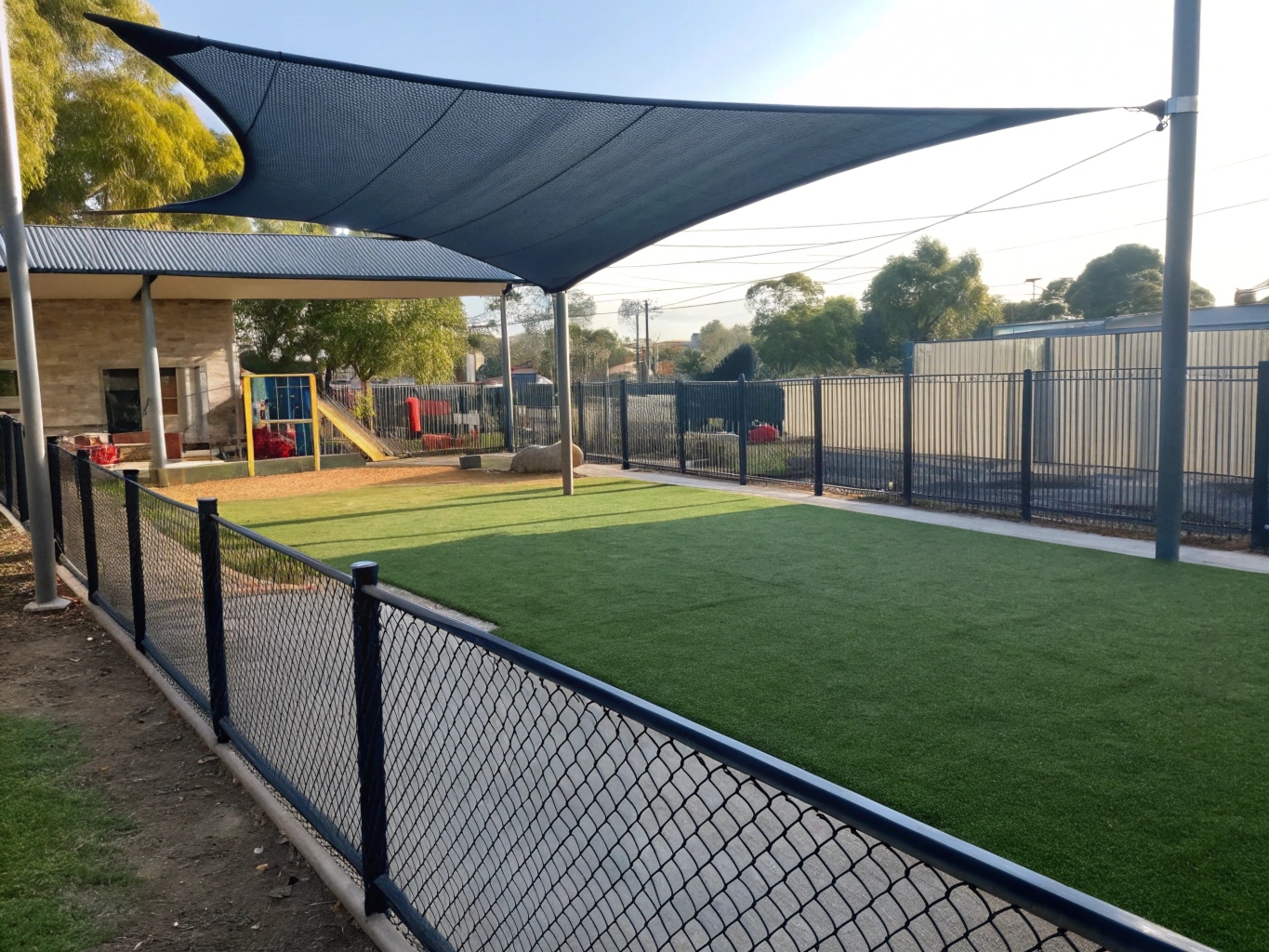 Soft fall synthetic turf installed around play equipment at a childcare centre
