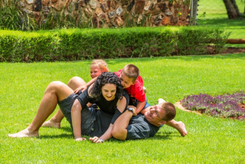 family playing outside on the lawn