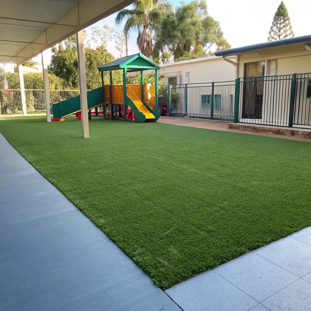 Commercial grade synthetic grass installed at a childcare outdoor play area